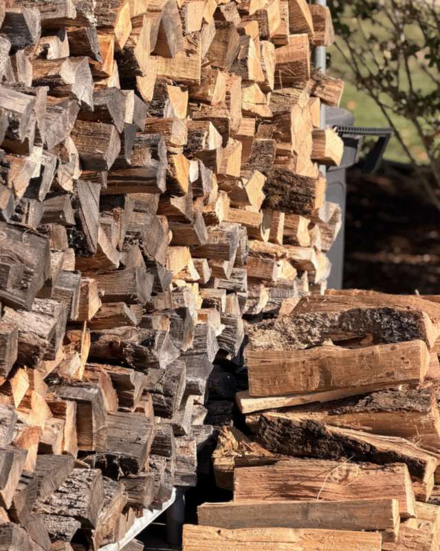 Close-up of seasoned split oak stacked high